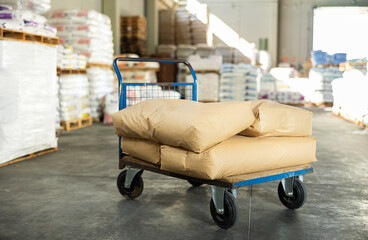 Paper bags are stacked on top of each other and lie in large stacks in warehouse of building...