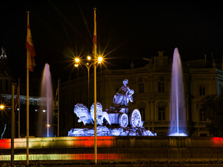 A nice photo of the Plaza de la Cibeles in Madrid, Spain, illuminated with the colors of the Spanish flag, where Real Madrid celebrates its trophies.