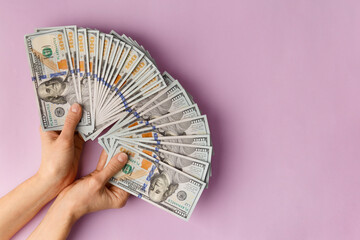 Dollars in hands on ? pink background