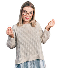 Young blonde woman wearing glasses doing money gesture with hands, asking for salary payment,...