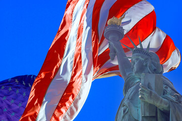 Statue of Liberty is paired with an American flag with beautifully waving stars and stripes as...