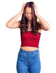 Fototapeta premium Young beautiful chinese girl wearing casual clothes suffering from headache desperate and stressed because pain and migraine. hands on head.