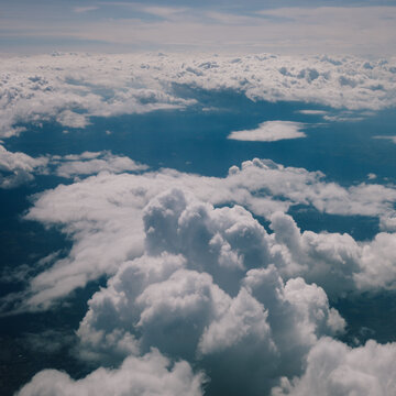 Aerial view on clouds and sky from airliner plane
