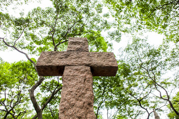 Stone cross with tree in the background, cemetery