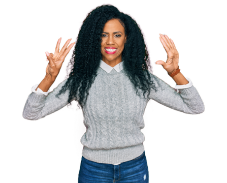 Middle age african american woman wearing casual clothes showing and pointing up with fingers number eight while smiling confident and happy.