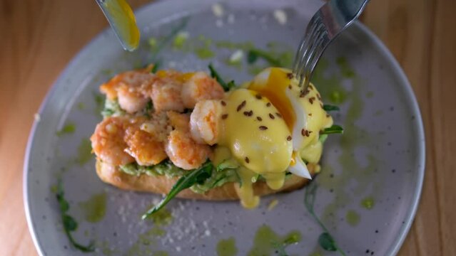bruschetta with shrimp and poached egg on a plate. Restaurant service. High quality 4k footage