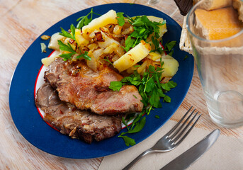 Grilled pork chop steak on plate served with boiled potatoes