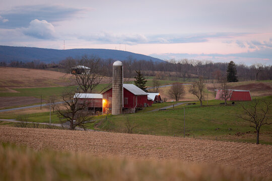 View of red barn and silo near crop field on Pennsylvania farm 