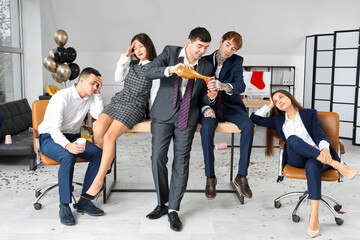 Group of drunk business colleagues after New Year party in office