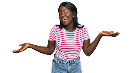 African young woman wearing casual striped t shirt clueless and confused expression with arms and...