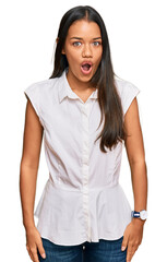 Beautiful hispanic woman wearing casual clothes scared and amazed with open mouth for surprise, disbelief face