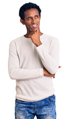 African handsome man wearing casual winter sweater with hand on chin thinking about question, pensive expression. smiling with thoughtful face. doubt concept.