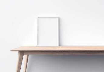 Blank frame template on wooden table