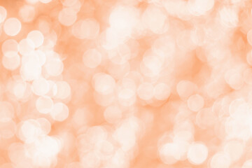 Blurred bokeh background trending color of year 2024 Peach Fuzz.