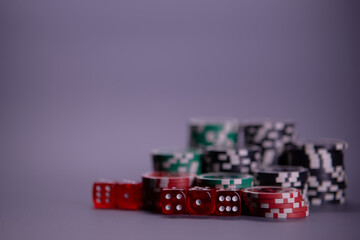 Casino games and gambling concept with stacked poker chips and red dice used in the game of craps. Copy space.