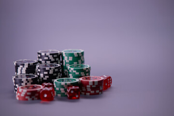 Casino games and gambling concept with stacked poker chips and red dice used in the game of craps. Copy space.
