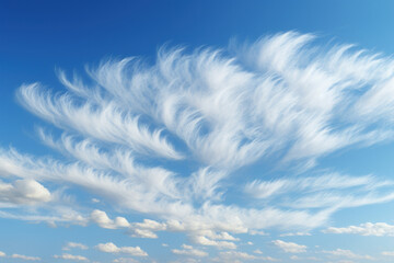 Wispy cirrus clouds streaking across a brilliant blue sky, creating a delicate contrast of...