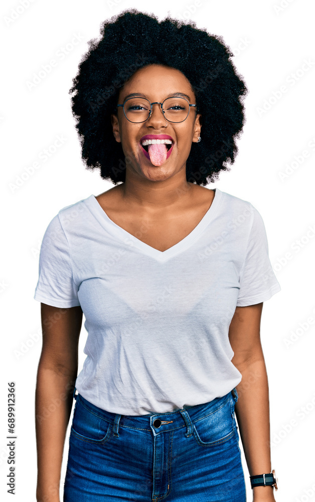 Poster young african american woman wearing casual white t shirt sticking tongue out happy with funny expre