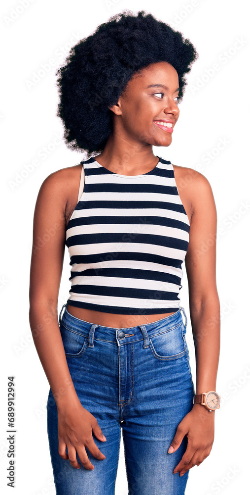 Poster Young african american woman wearing casual clothes looking away to side with smile on face, natural expression. laughing confident.