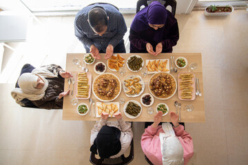 Family eating together with multi generation members in modern living room