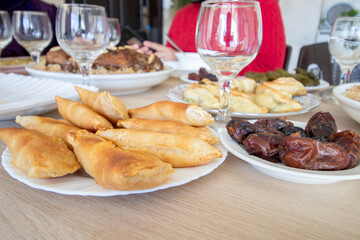 Dish for dates and qatayef on wooden table for ramadan iftar