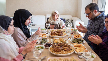 Family eating together with multi generation members in modern living room
