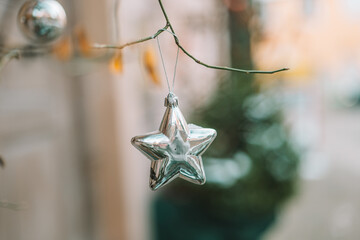  silver street decor.star on tree branches on winter city streets. Soft focus.Christmas season in Europe. Winter holiday decor