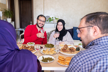 Family eating together with multi generation members in modern living room