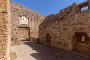 Coat of arms on the old stone city wall in the city of Rhodes.