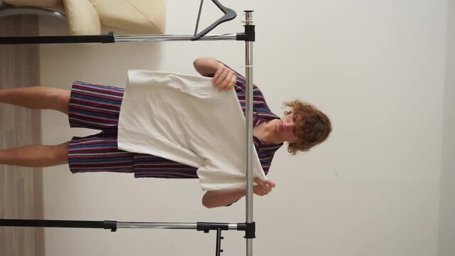 man tears clothes vertical video