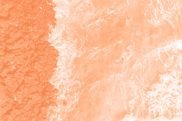 Sea and volcanic rocks trending color of year 2024 Peach Fuzz.