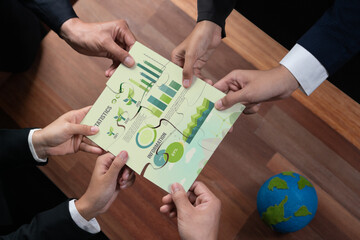 Cohesive group of business people forming jigsaw puzzle pieces in environmental awareness symbol as...