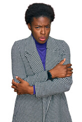 Young african american girl wearing casual clothes shaking and freezing for winter cold with sad...