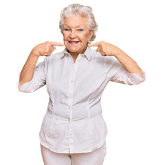 Senior grey-haired woman wearing casual clothes smiling cheerful showing and pointing with fingers teeth and mouth. dental health concept.