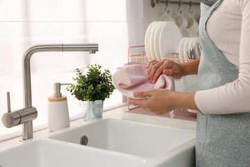 Woman wiping bowl with towel in kitchen, closeup - obrazy, fototapety, plakaty