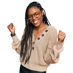African american woman wearing casual clothes very happy and excited doing winner gesture with arms...