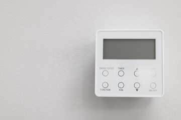 One thermostat on white wall indoors, space for text. Smart home system