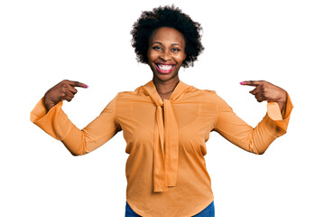 African american woman with afro hair wearing elegant shirt looking confident with smile on face,...