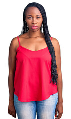 Young african american woman wearing casual clothes skeptic and nervous, frowning upset because of...