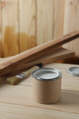 Can with wood stain on wooden surface. Space for text