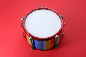 Colorful drum on red background. Percussion musical instrument