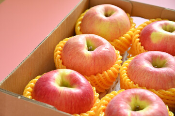 beautiful pink apple in the box on pink background
