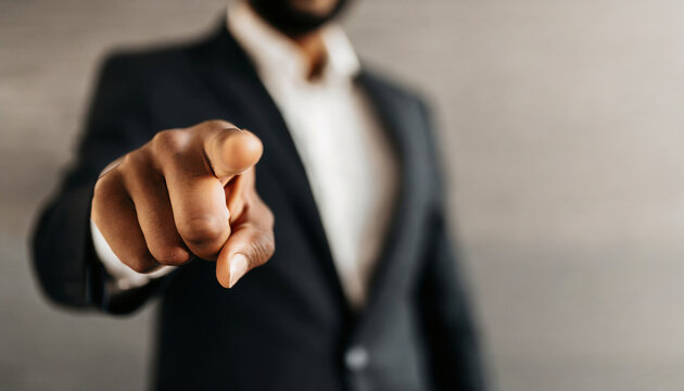businessman pointing directly at viewer with copy space, conveying authority and direction in business communication