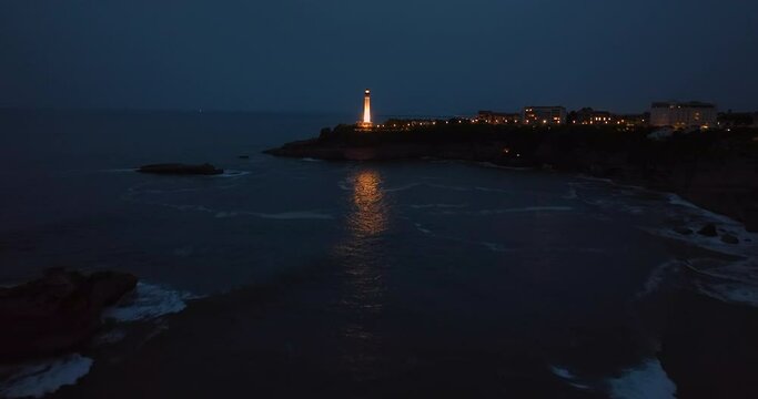 Biarritz, France Aerial view rocky cliff and lighthouse of Biarritz in the night. Timelapse