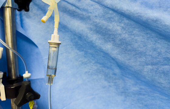 hospital intravenous infusion with medication dripping into tubing, healthcare concept