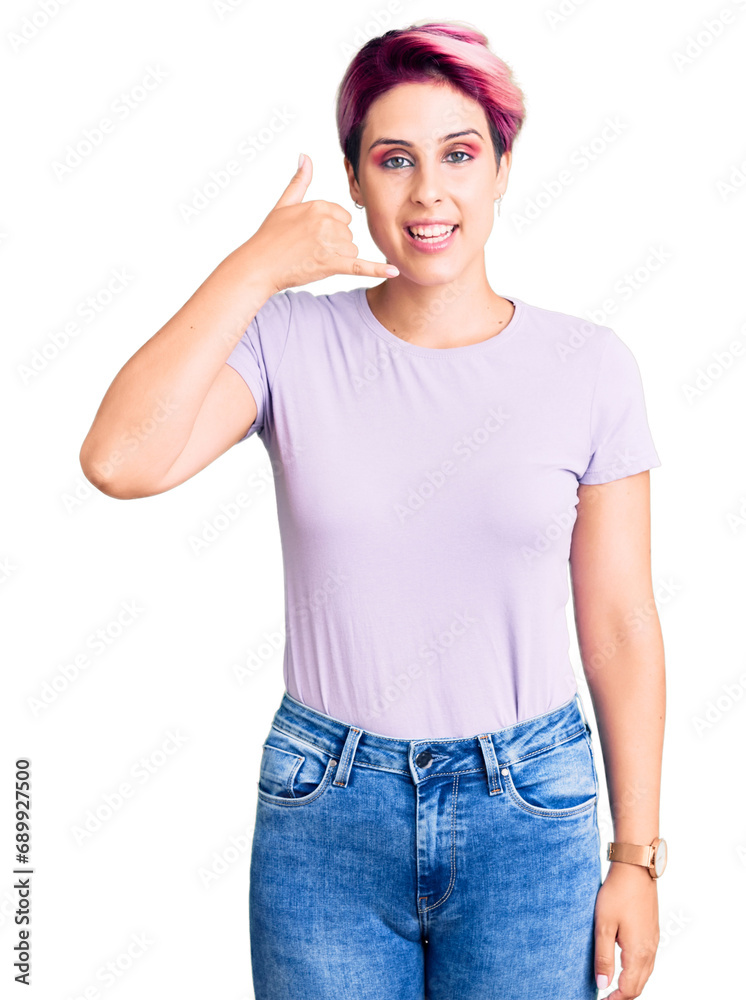 Sticker young beautiful woman with pink hair wearing casual clothes smiling doing phone gesture with hand an