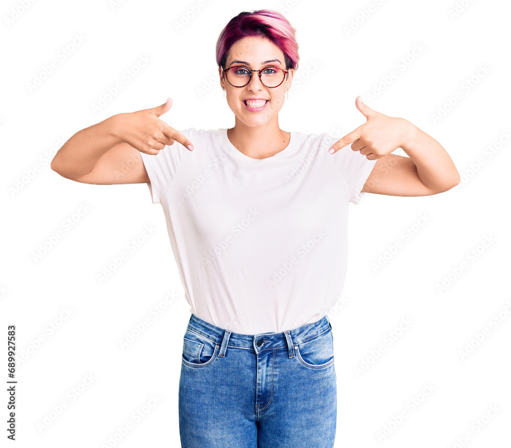 Wall mural Young beautiful woman with pink hair wearing casual clothes and glasses looking confident with smile on face, pointing oneself with fingers proud and happy.