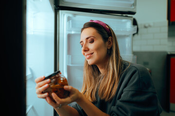 Woman Checking the Expiration Date on a Mushroom Jar . Informed consumer reading the nutritional...