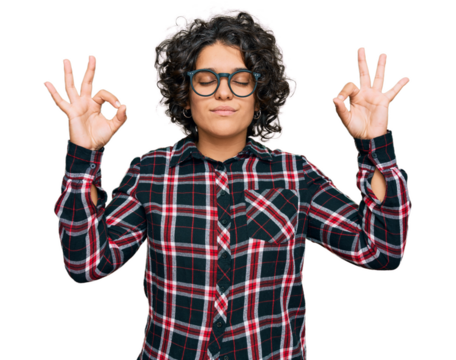Young hispanic woman with curly hair wearing casual clothes and glasses relax and smiling with eyes closed doing meditation gesture with fingers. yoga concept.