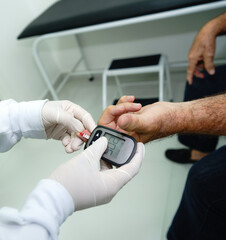 doctor performing the procedure on a diabetic patient aged between 70 and 80 years old